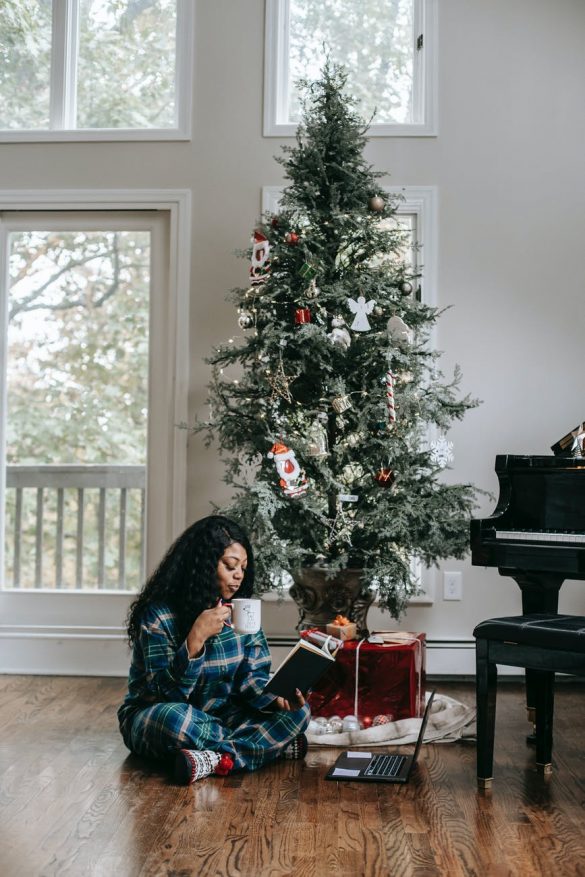 calm black woman drinking coffee and reading book